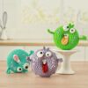 Personifed Buggy Eyed Colorful Crochet Donuts with tongues sticking out.