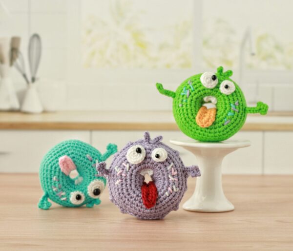 Personifed Buggy Eyed Colorful Crochet Donuts with tongues sticking out.